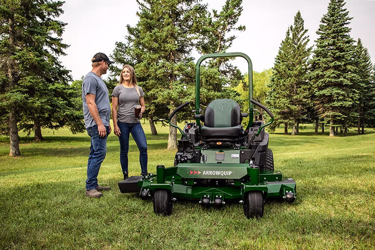 Two people reviewing Arrowquip Mowers zero-turn mower, built for durability and easy maintenance