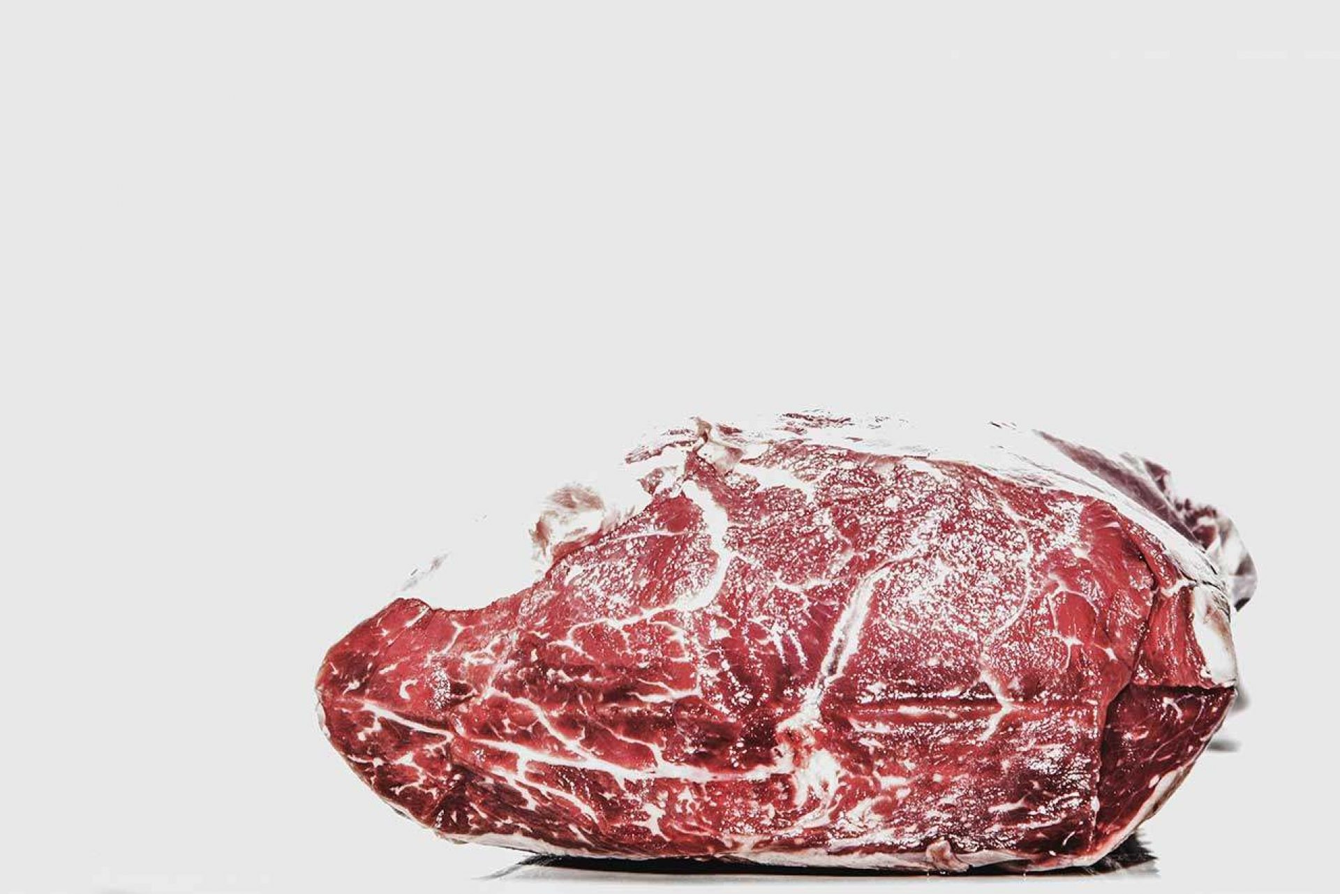 Cut of beef with marbling on white background