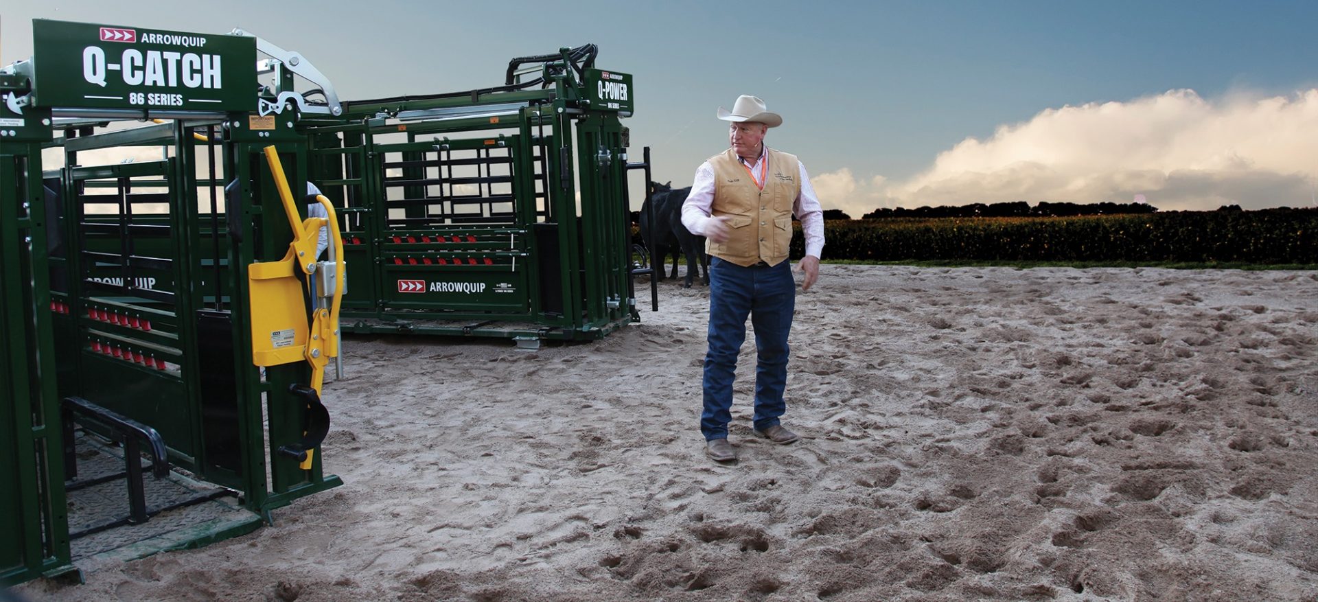 Dr Ron Gill standing next to Q-Catch 86 Series Cattle Chute and Q-Power 106 Series Hydraulic Chute at the NCBA