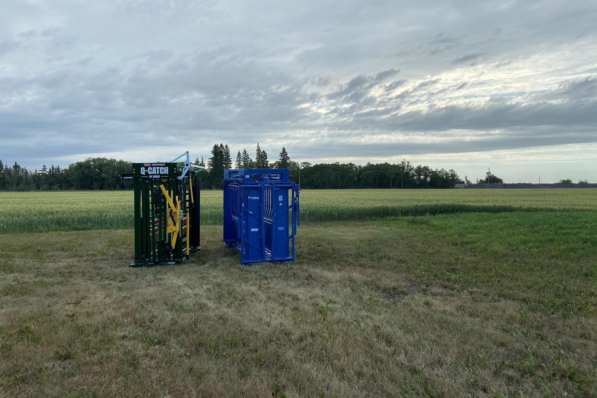 87 series cattle chute next to priefert cattle chute in fornt of a field