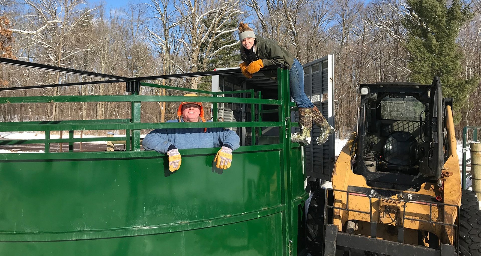 Young female cattle rancher working alongside her dad to install a cattle tub